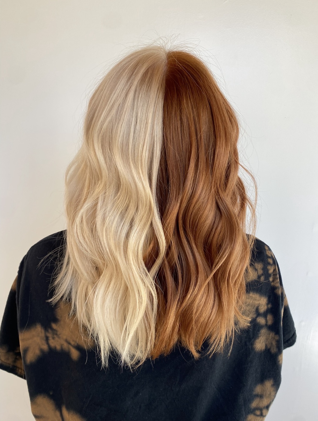 Half blonde and half copper split hair color